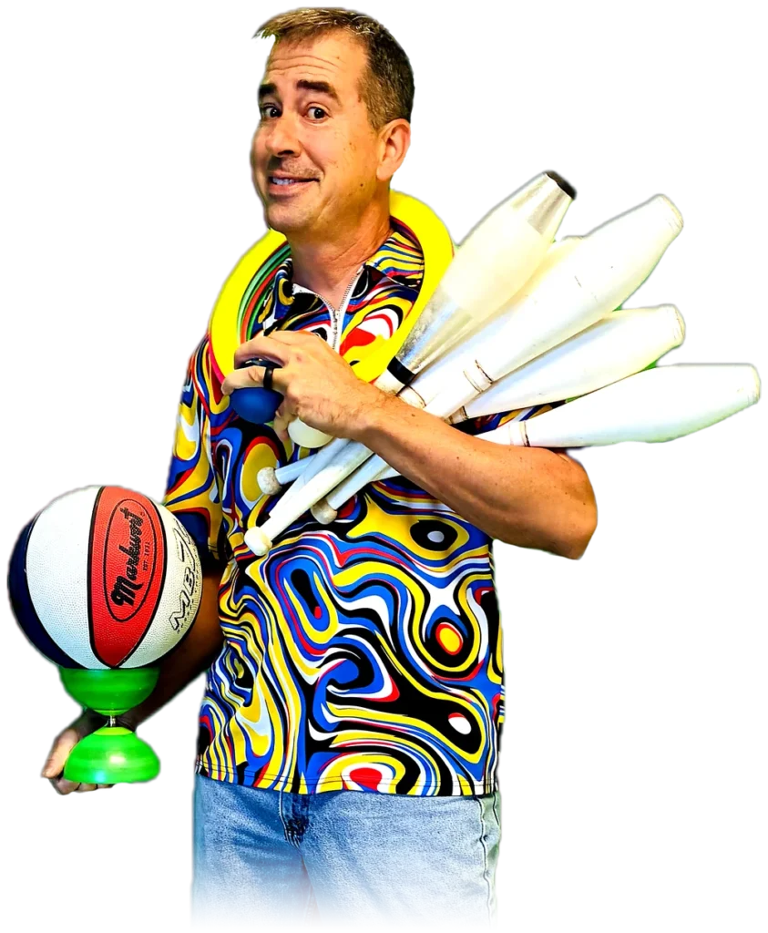Nathan Dorrell, the Crazy Tie Guy, holding juggling clubs, rings, a basketball and a diabolo